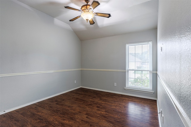 spare room with dark hardwood / wood-style flooring, lofted ceiling, and ceiling fan