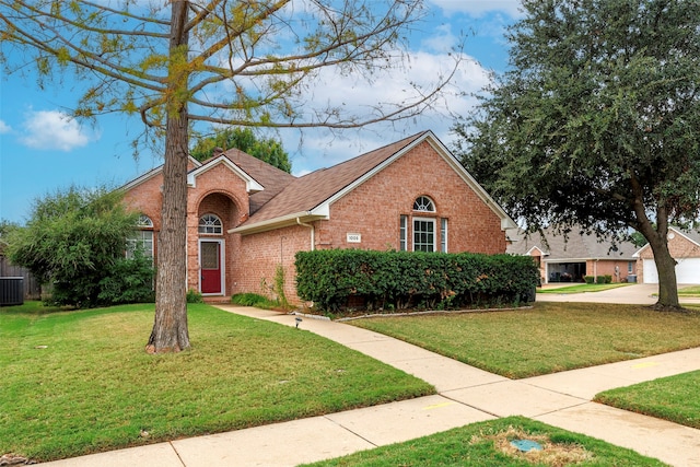 view of front of home featuring central AC unit and a front lawn