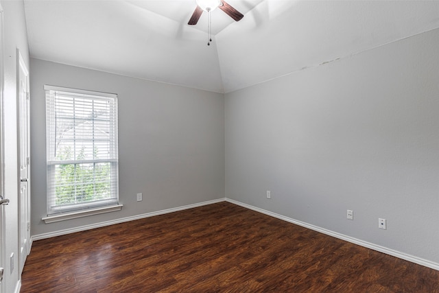 empty room with dark hardwood / wood-style flooring, lofted ceiling, and ceiling fan