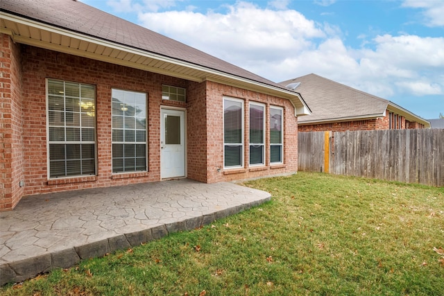 back of house featuring a yard and a patio