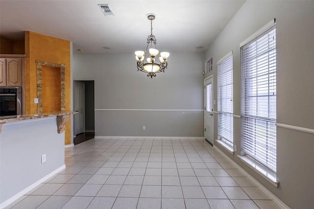 1005 Carina Ct, Arlington, TX 76013 - unfurnished dining area featuring plenty of natural light, light tile patterned floors, a chandelier, and baseboards