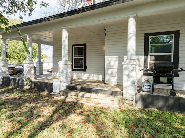 view of patio with area for grilling and covered porch