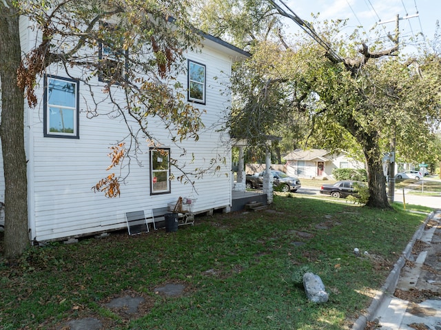 view of side of property featuring a yard