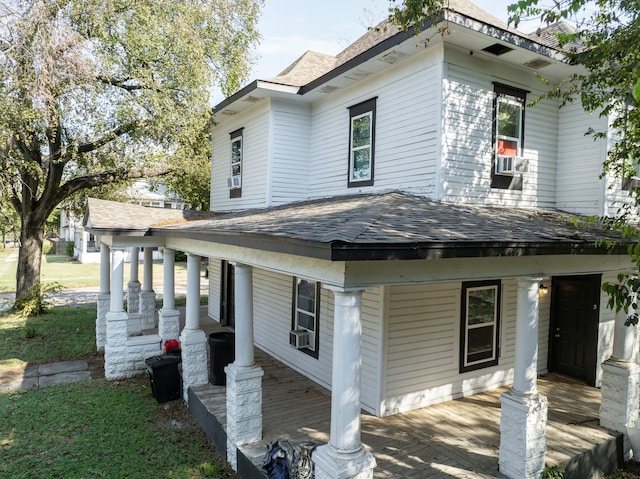 view of front of house featuring cooling unit and covered porch