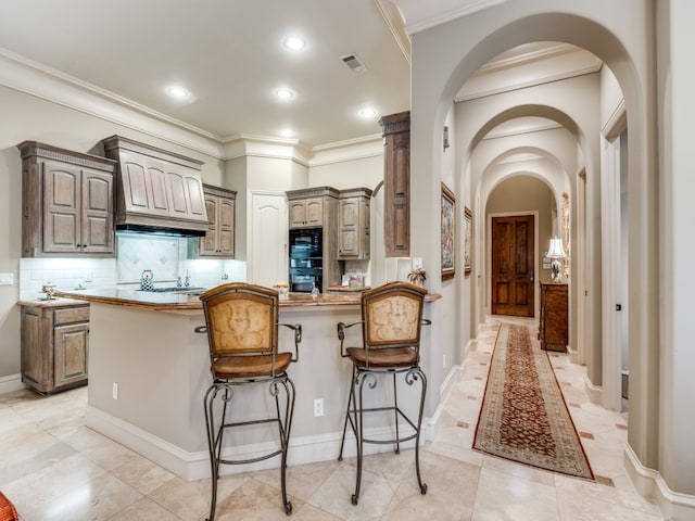 kitchen featuring tasteful backsplash, premium range hood, light tile patterned flooring, and black microwave