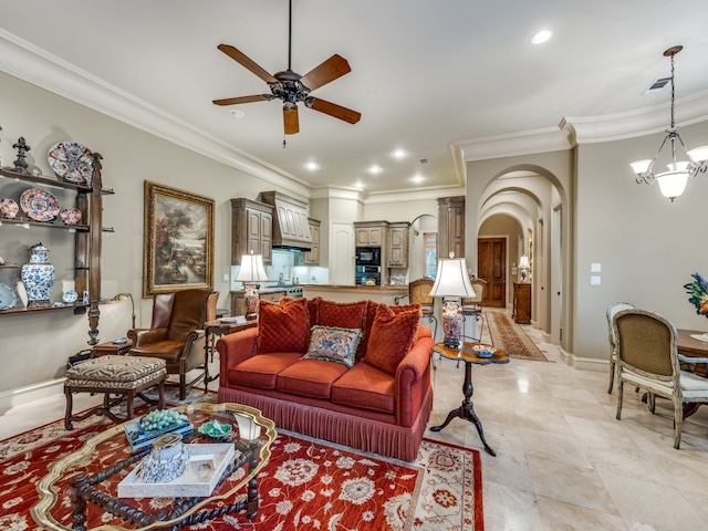 tiled living room with ceiling fan with notable chandelier and crown molding