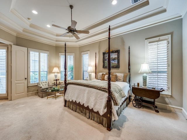 bedroom featuring ceiling fan, multiple windows, and light colored carpet