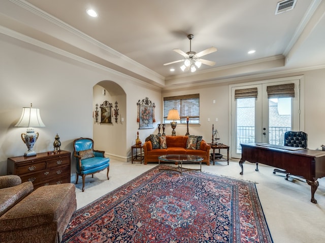 carpeted living room with french doors, ceiling fan, crown molding, and a tray ceiling