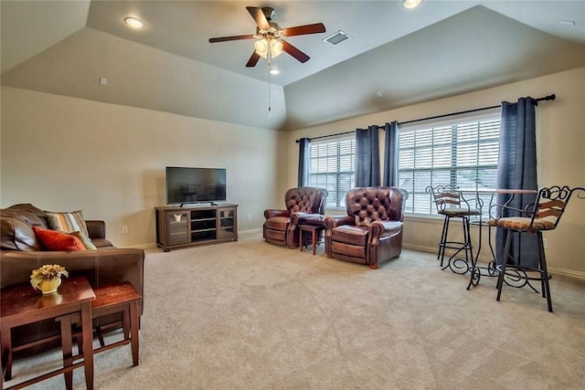 living room featuring light colored carpet, vaulted ceiling, and ceiling fan