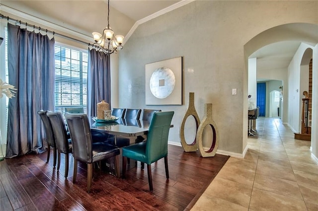 dining room featuring hardwood / wood-style floors, a chandelier, and ornamental molding