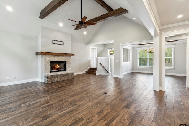 unfurnished living room with ornamental molding, a stone fireplace, dark hardwood / wood-style floors, high vaulted ceiling, and beamed ceiling