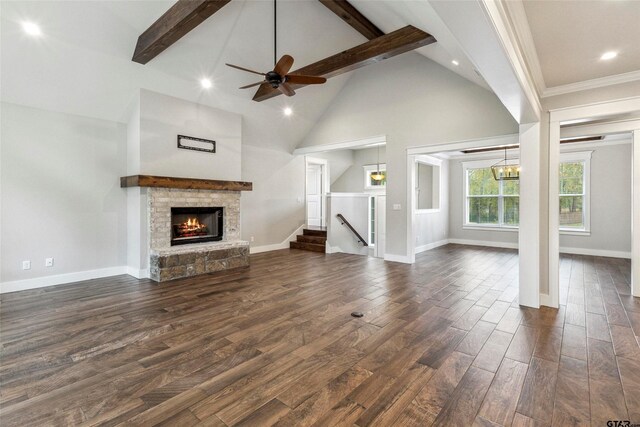 unfurnished living room with ornamental molding, a stone fireplace, dark hardwood / wood-style floors, high vaulted ceiling, and beamed ceiling