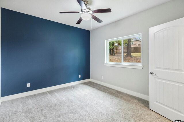 spare room with ceiling fan and carpet floors