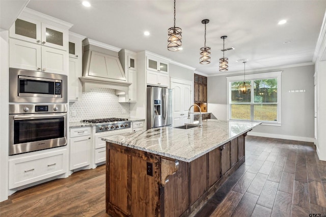 kitchen featuring stainless steel appliances, a center island with sink, white cabinetry, and dark hardwood / wood-style flooring