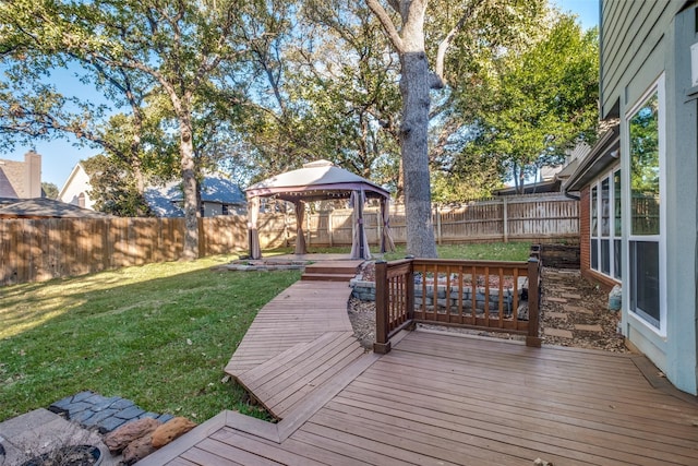 deck featuring a gazebo and a lawn