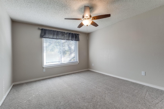 unfurnished room featuring ceiling fan, carpet, and a textured ceiling