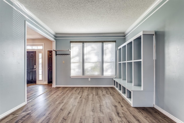 mudroom with ornamental molding, wood-type flooring, and a textured ceiling