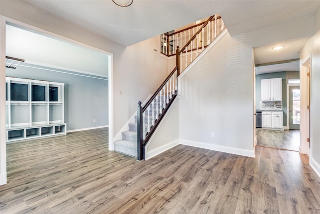 foyer featuring hardwood / wood-style flooring and a textured ceiling