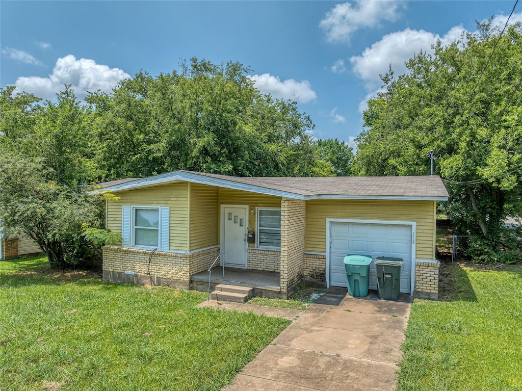 2120 N Hickory St, Sherman, TX 75092 - view of front of house featuring driveway, a garage, brick siding, and a front yard
