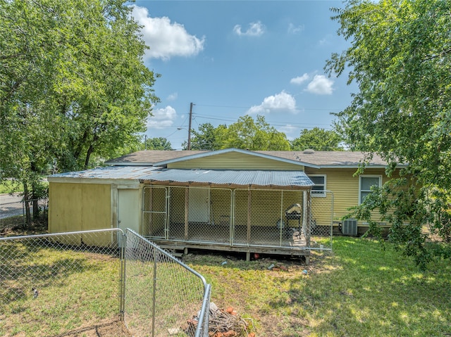 rear view of house featuring central AC unit