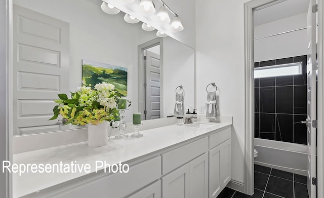 full bathroom with toilet, vanity, tiled shower / bath, and tile patterned floors