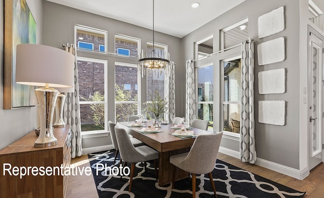 dining area featuring hardwood / wood-style flooring and a chandelier