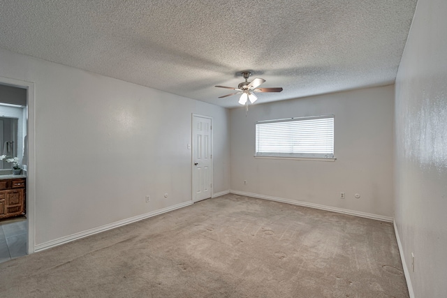 spare room featuring ceiling fan and light carpet