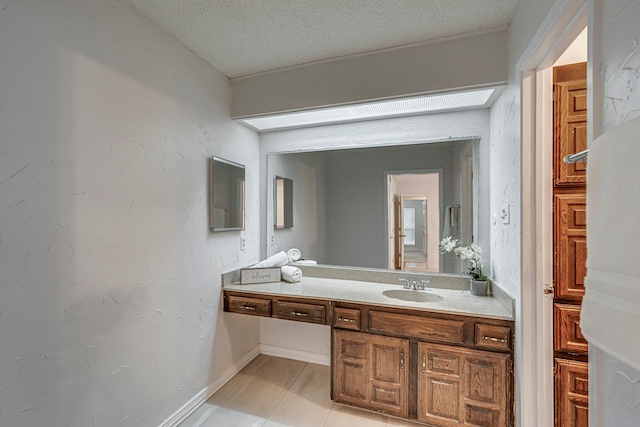 bathroom with tile patterned floors, vanity, and a textured ceiling