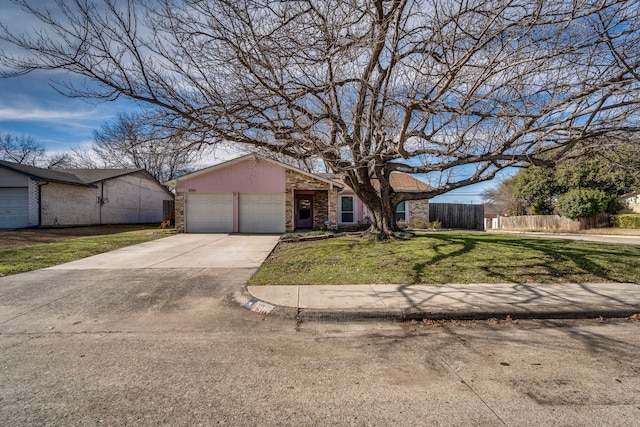 ranch-style home featuring a garage and a front lawn