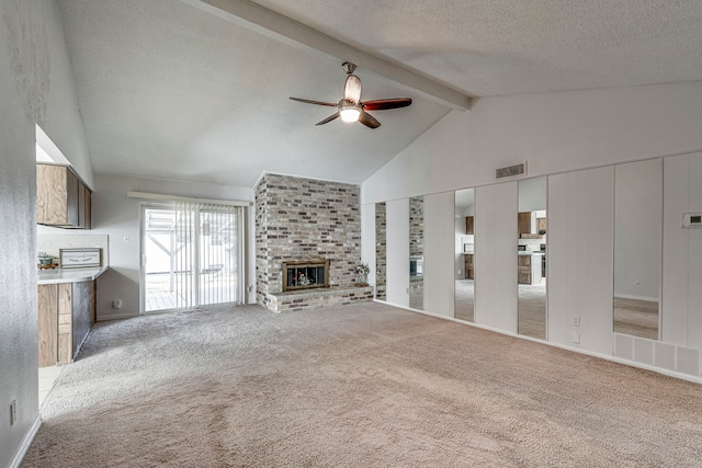 unfurnished living room featuring vaulted ceiling with beams, ceiling fan, a fireplace, a textured ceiling, and light colored carpet