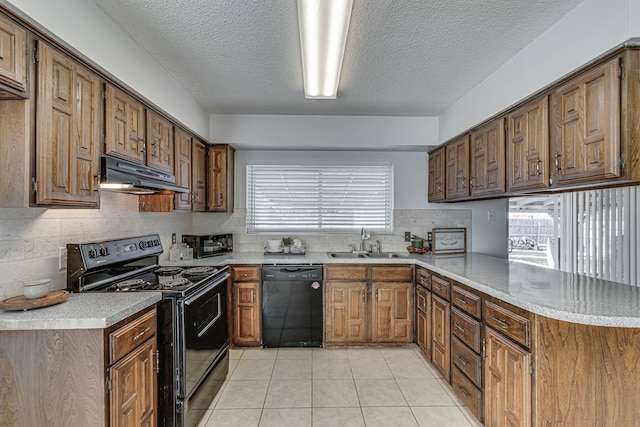 kitchen with black appliances, sink, light tile patterned floors, a textured ceiling, and kitchen peninsula