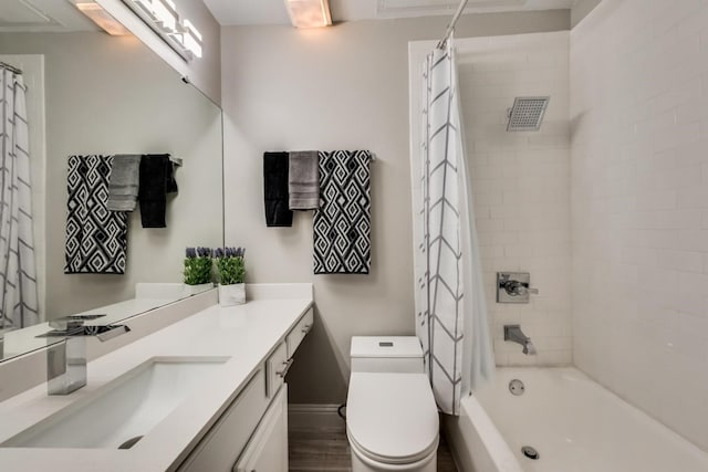 full bathroom featuring hardwood / wood-style floors, vanity, toilet, and shower / tub combo