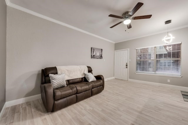 living room with ceiling fan, light wood-type flooring, and crown molding