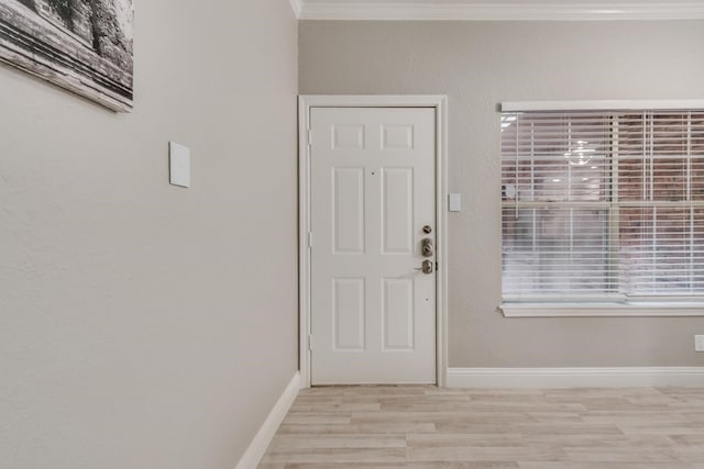 doorway to outside with light hardwood / wood-style flooring and ornamental molding