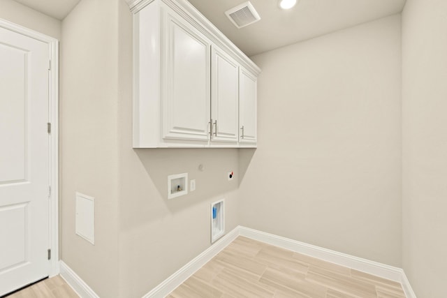 laundry area with cabinet space, visible vents, hookup for a gas dryer, light wood-style flooring, and electric dryer hookup