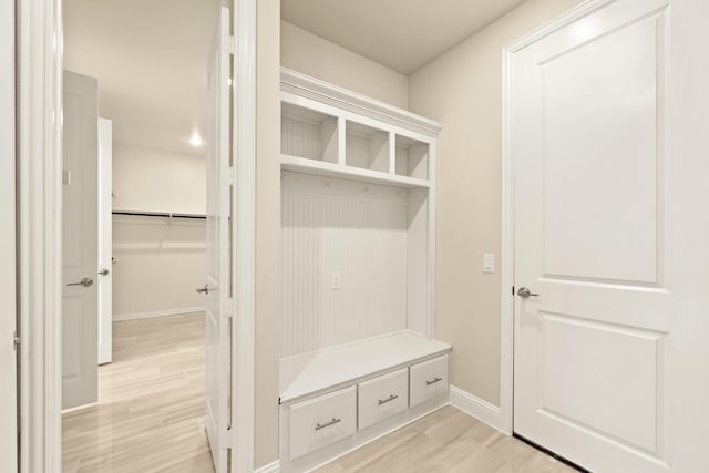 mudroom with light wood-type flooring and baseboards