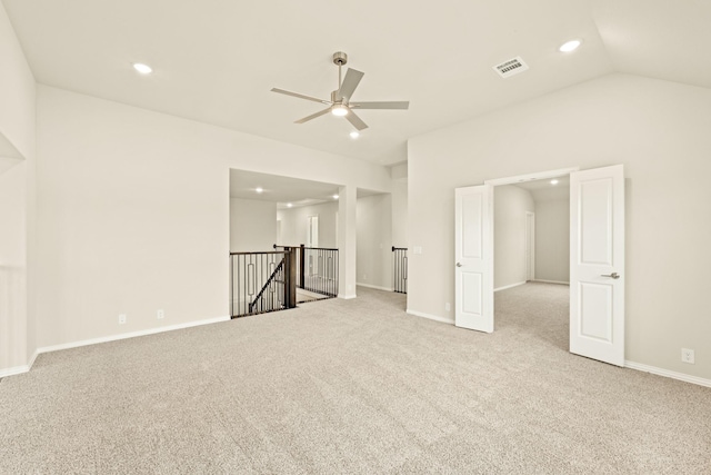 empty room featuring baseboards, visible vents, lofted ceiling, carpet flooring, and recessed lighting