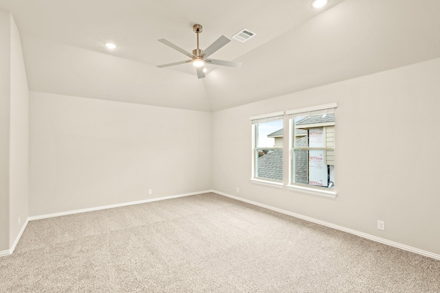 unfurnished room featuring baseboards, visible vents, ceiling fan, vaulted ceiling, and carpet floors