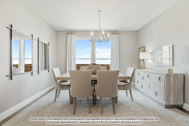 dining space with a notable chandelier and a water view