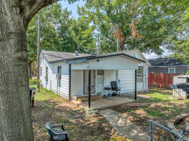 back of property with a patio