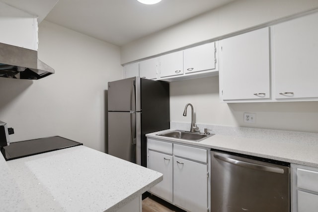 kitchen with extractor fan, white cabinets, sink, and stainless steel appliances