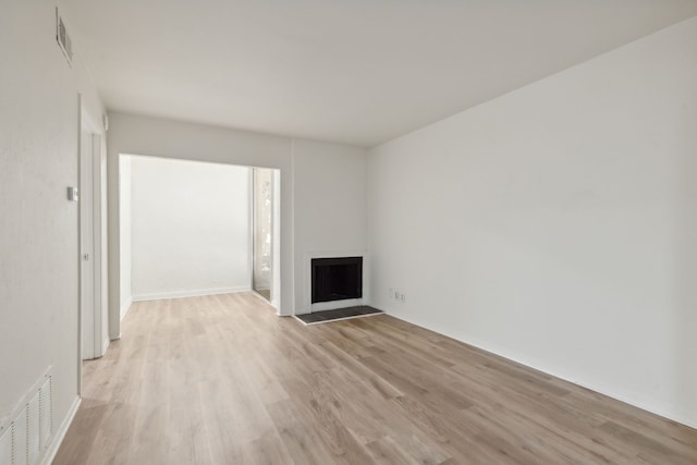 unfurnished living room with light hardwood / wood-style flooring