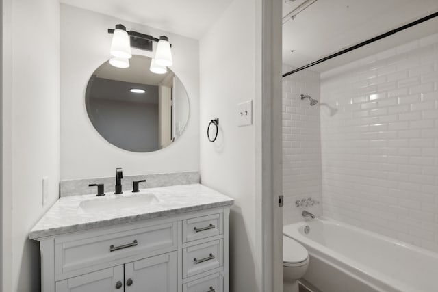 full bathroom featuring vanity, toilet, and tiled shower / bath combo