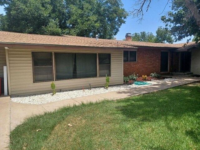 single story home featuring a garage and a front yard