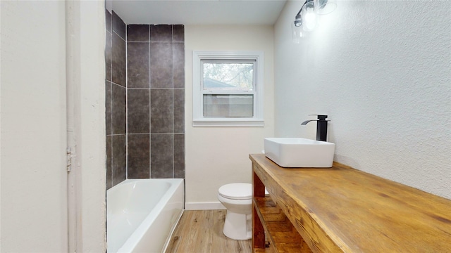 bathroom featuring wood-type flooring, toilet, and vanity