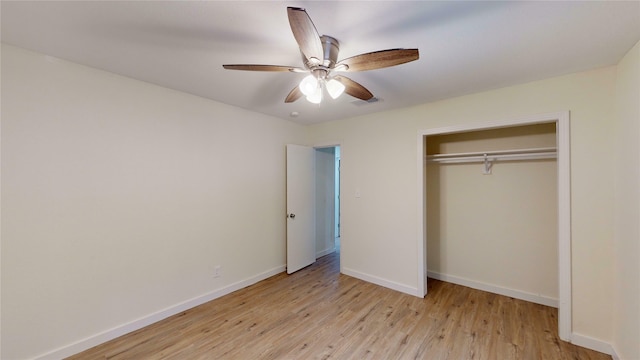 unfurnished bedroom featuring ceiling fan, a closet, and light hardwood / wood-style flooring