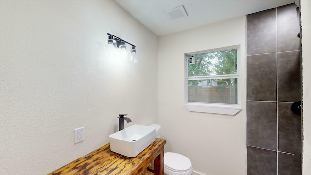 bathroom featuring sink and toilet