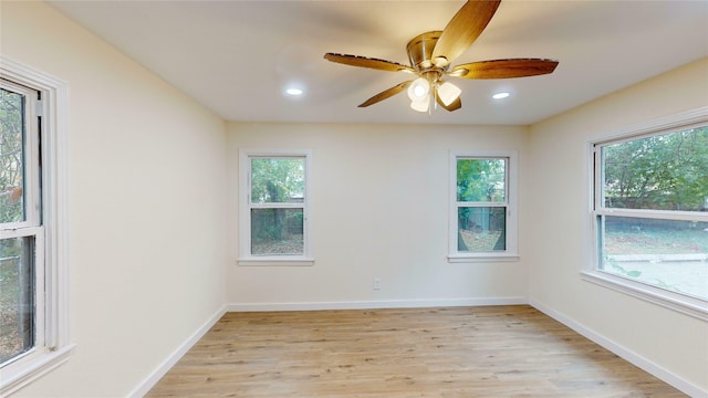 empty room with ceiling fan and light hardwood / wood-style floors