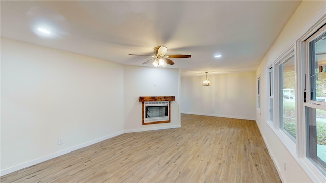 unfurnished living room with ceiling fan and light wood-type flooring