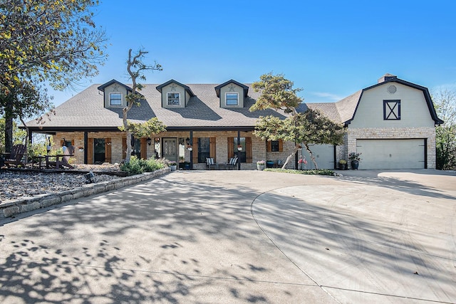 view of front of house featuring covered porch and a garage